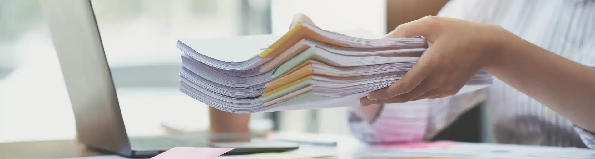 holding_stack_of_documents_with_laptop office meeting team discussion