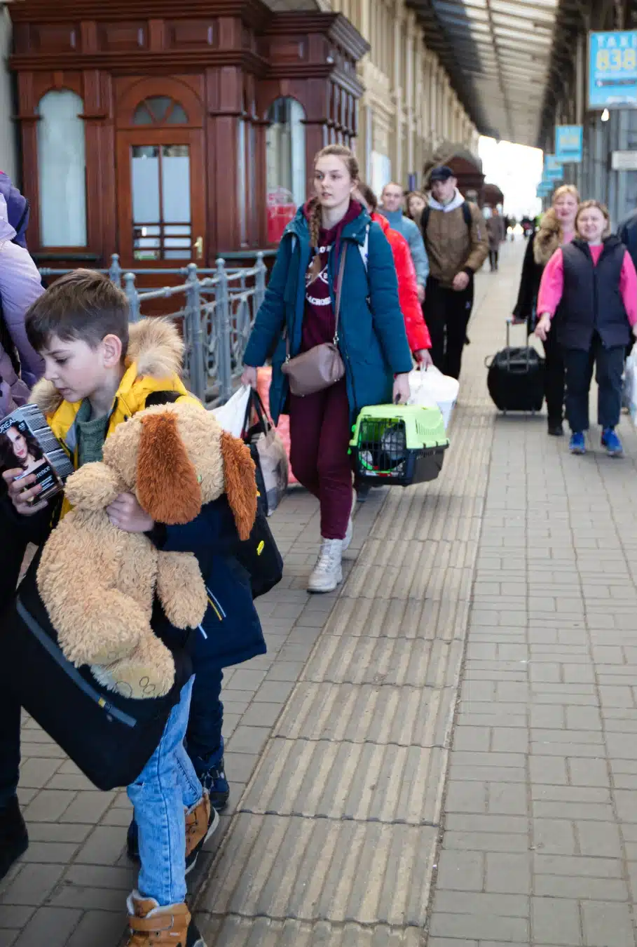people with luggage on train platform