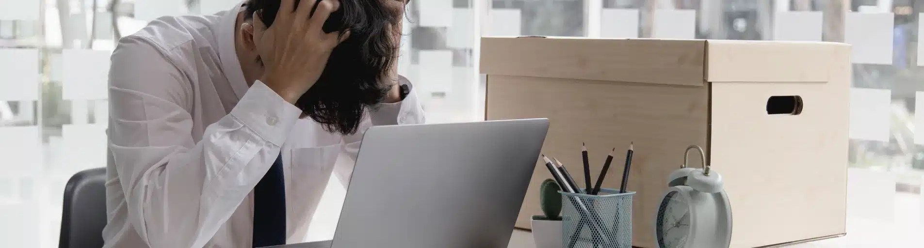 person frustrated at office desk person frustrated at office desk