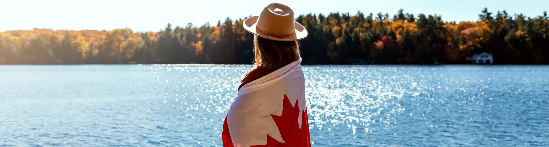 woman with canadian flag near lake woman with canadian flag near lake